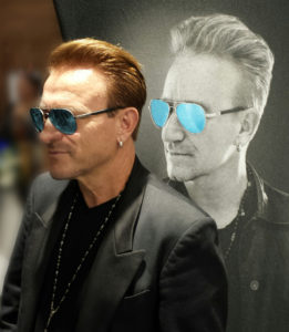 Pavel Sfera as Bono wearing teal aviator shades